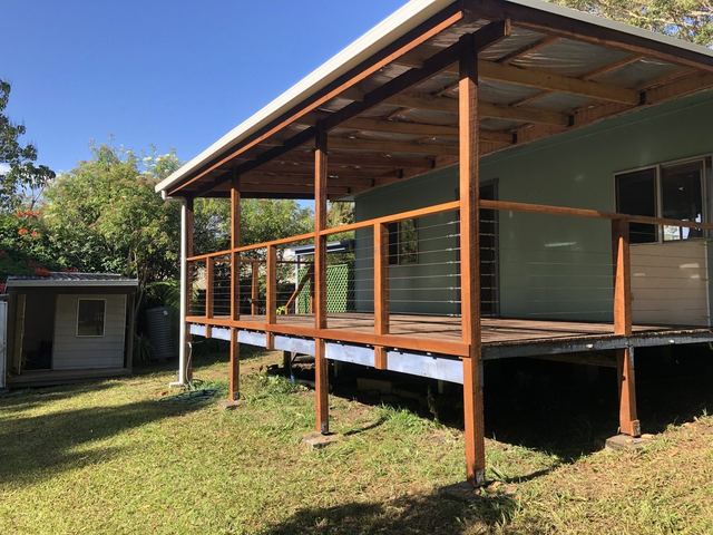 Covered timber deck with a skillion roof and wire balustrade