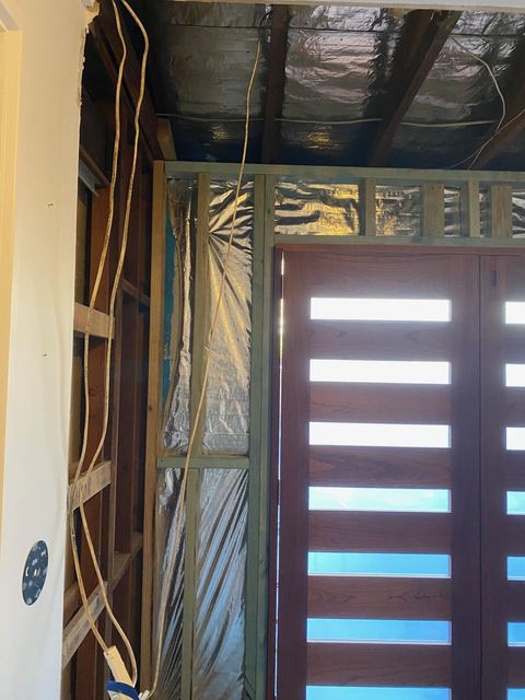 Custom timber door with glass slats being fitted