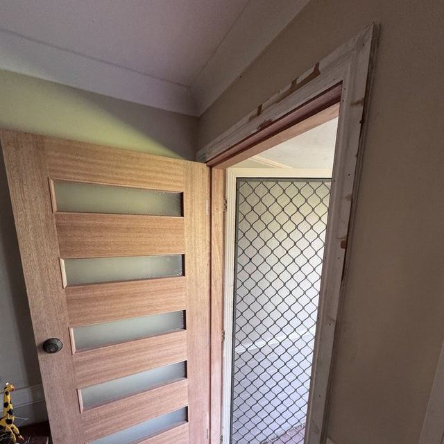 Finished internal timber door with glass panels and new architraves