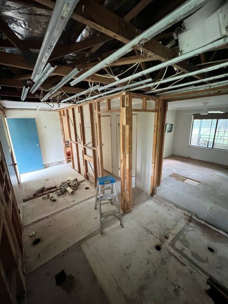 Room stripped back to the frame with old linings and rubbish on the floor
